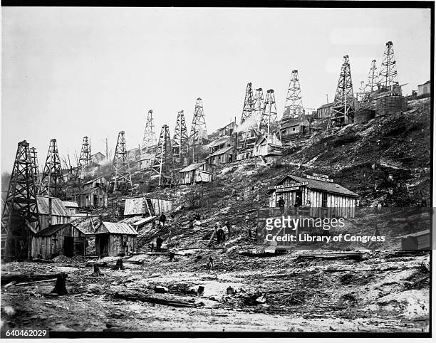 Derricks belonging to the Shoe & Leather Petroleum Company and the Foster Farm Oil Company cover a hillside in Pennsylvania. | Location: Pioneer Run,...