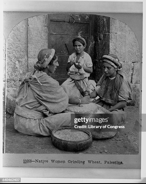 Woman and Girls Grinding Wheat