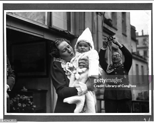 Hermann Goering takes a picture of his wife Emmy as she holds Edda, their infant daughter.