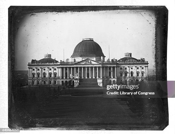 Capitol in 1846, with the central dome designed by architect Charles Bulfinch. This dome was later replaced by one designed by Thomas U. Walter.