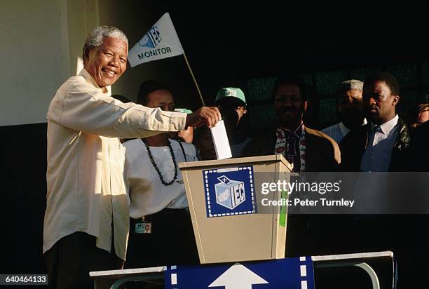 Former political prisoner and presidential candidate Nelson Mandela casts his vote at the ballot box on election day.