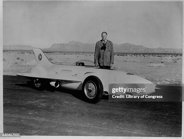 Harley Earl, a designer for General Motors stands on the General Motors test track beside the 1954 Firebird XP-21 he designed. Arizona.