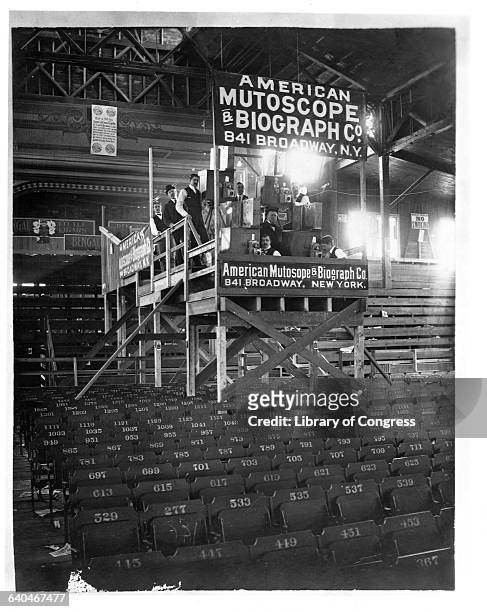 Film crew from the American Mutoscope and Biograph Company stands on a platform with the gear necessary to film the interior of this Coney Island...