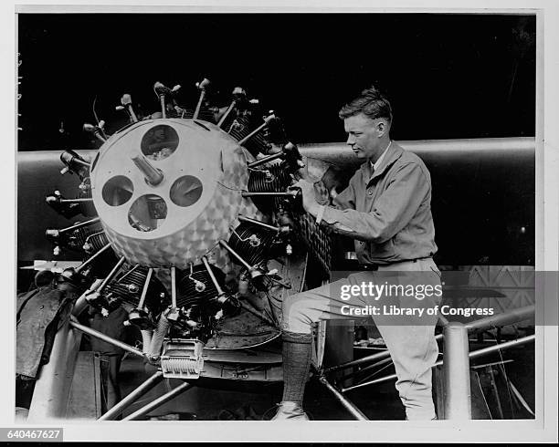 Charles Lindbergh examines the engine cylinders on the Spirit of St. Louis.