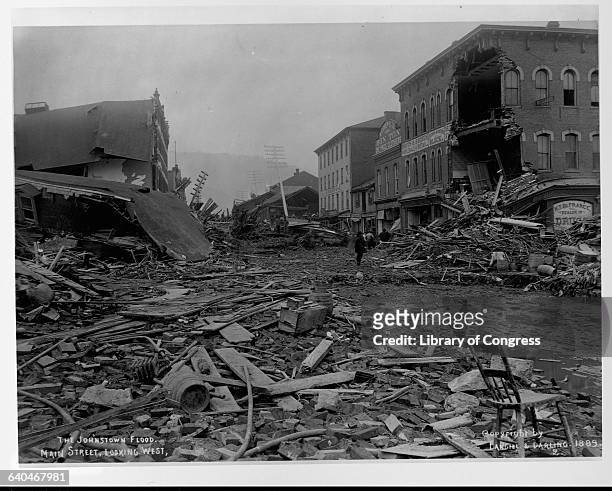 Debris fills Main Street in Johnstown, Pennsylvania between two rows of ruined buildings. The flood of 1889 killed over 2,000 people.
