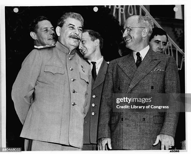 Premier Joseph Stalin and President Harry S. Truman smiling during the Potsdam Conference. Presidential advisor Charles E. Bohlen stands in the...