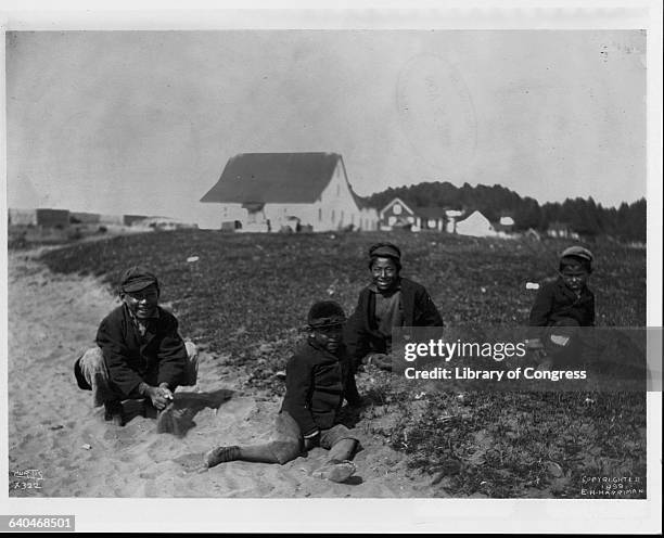 Photograph of four boys taken during the Harriman Alaska Expedition of 1899. | Location: Alaska Territory, USA.