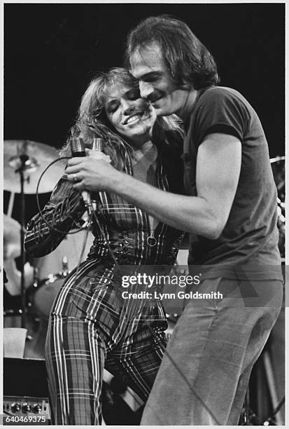 Carly Simon and James Taylor performing at Madison Square Garden during the No Nukes concert sponsored by Warner Brothers.