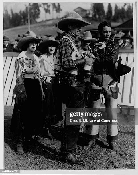 Businessman and politician William Gibb McAdoo presents a trophy to champion rodeo cowboy Yakima Canutt in 1924. Other prominent rodeo performers,...