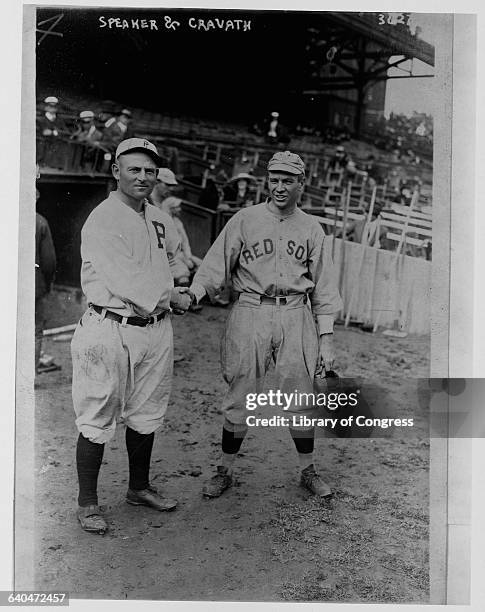 Outfielder Gavvy Cravath of the Philadelphia Phillies shakes hands with Tris Speaker, star outfielder for the Boston Red Sox, at Boston's Fenway Park...