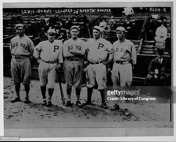 Members of the Philadelphia Phillies and the Boston Red Sox stand together at Boston's Fenway Park before Game 3 of the 1915 World Series. They are:...