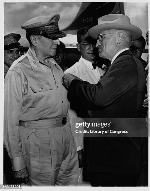 General Douglas MacArthur receiving a Distinguished Service Medal from President Harry S. Truman on Wake Island.