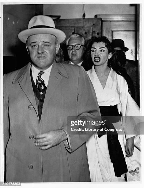 Singer Maria Callas, dressed in a white costume, shouts angrily at U.S. Marshal Stanley Pringle backstage after a performance of Madame Butterfly at...