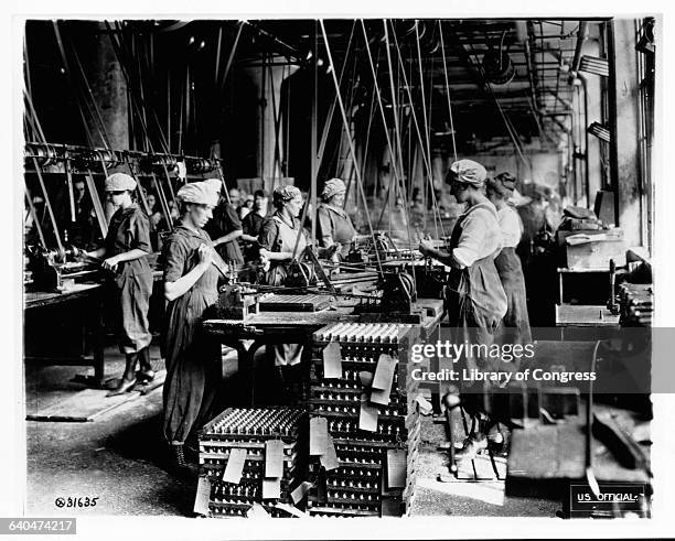 Spanner slotting fuse on head end of fuse bodies at Gray & Davis Co., Cambridge, Mass.; 2 photos lot 4008 woman - war work WWI-US WWI - industry