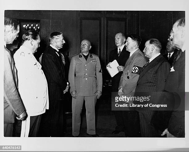 Neville Chamberlain, Adolph Hitler, Benito Mussolini, and Hermann Goering stand together at the Munich Conference in 1938.
