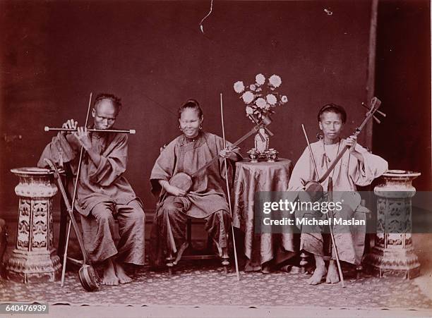 Group of blind musicians playing stringed instruments and a flute.