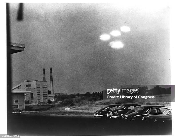 Four brightly glowing, unidentified objects appeared in the sky at 9:35 a.m. On July 15, 1952 over a parking lot.