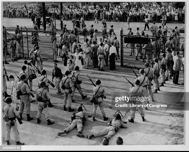 National Guardsmen oversee workers entering the Univis Lens Company during a strike in Dayton, Ohio, 1948