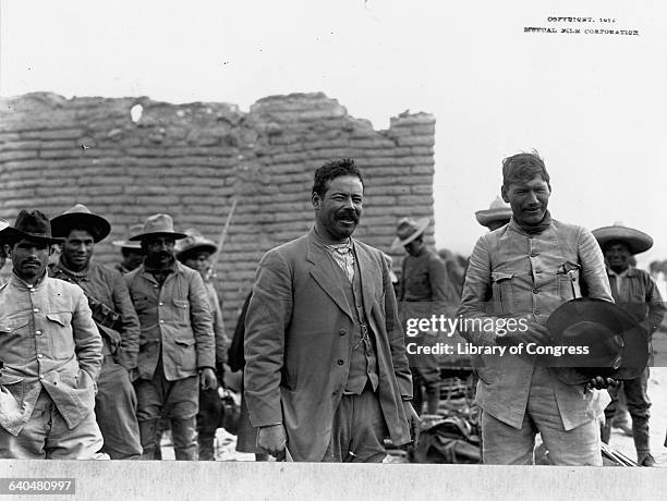 Generals Pancho Villa and Panfilo Natera stand with a group of Mexican rebels during the Mexican Revolution in 1914.