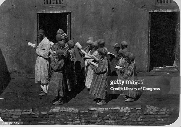 Teacher leads his students on a Samarkand street in the 1870s.