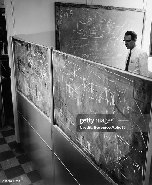 View of an unidentified engineer as he works on a series of blackboards at the IBM laboratory, late 1950s. Between 1958 and 1961, Abbott worked for...