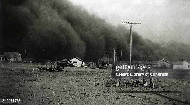 Huge dark dust clouds swarm over houses in rural Colorado. | Location: Springfield, Colorado, USA.