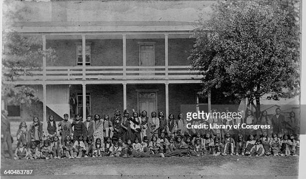 Young Sioux boys still dressed in traditional clothing pose outside a dormitory at the Carlisle Indian School, Pennsylvania, October 5, 1879.