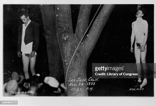 Two victims of a lynching, Holmes and Thurmond, hang from a tree on November 26, 1933. San Jose, California.