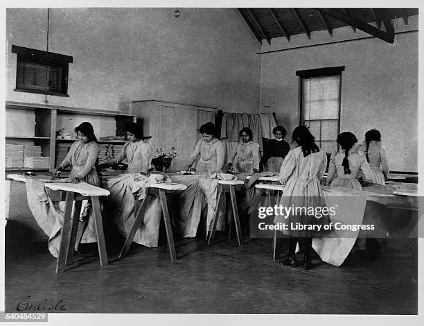 Group of North American Indian students learning how to iron during a laundry class at the Carlisle Indian School, Carlisle, Pennsylvania. |...