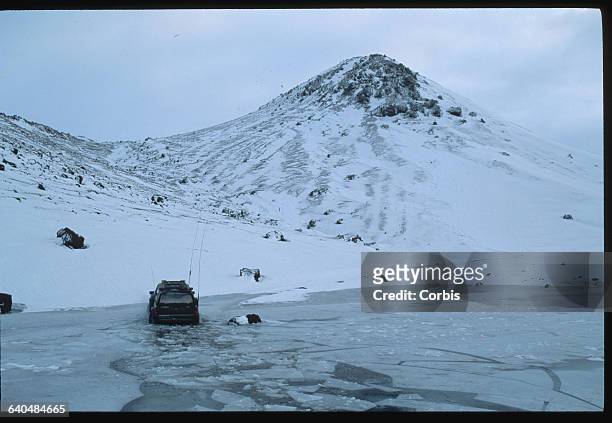 Truck Approaching Snowy Cinder Cone