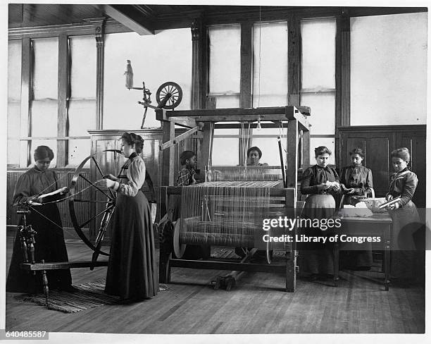 African American women weave a rug in a home economics class at the Hampton Institute, Hampton, Virginia, ca. 1899-1900.