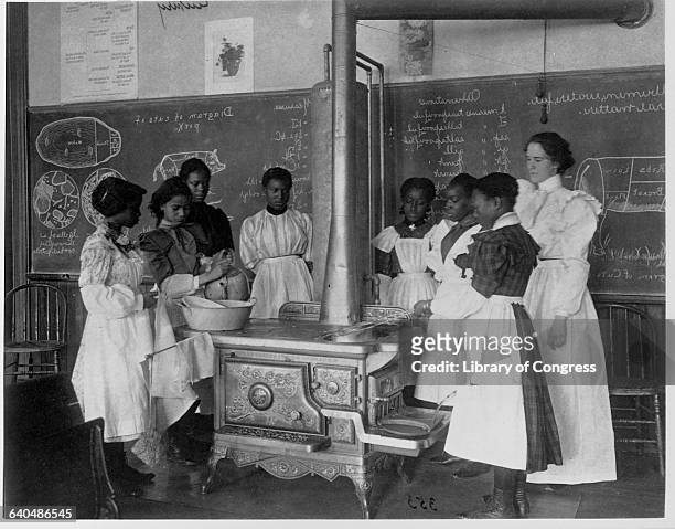 African American women attend cooking class in a 7th Division public school, Washington D.C., ca. 1899.