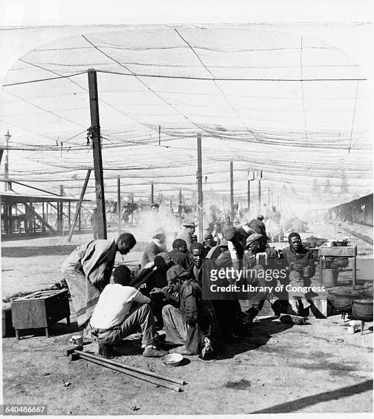 African employees during rest hour at the DeBeers Diamond Mine, South Africa, 1901. | Location: DeBeers Diamond Mining Compound, Kimberley, South...