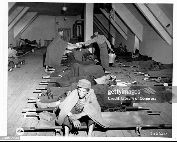 An American soldier cares for Hungarian Jews rescued from Nazi concentration camps at the close of World War II.