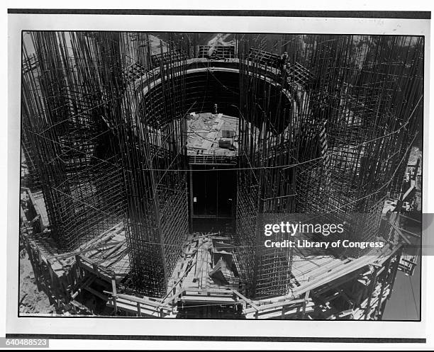 Massive steel bar columns rise in the construction of Boulder Dam. There is as much steel in the dam as is in the Empire State Building and enough...