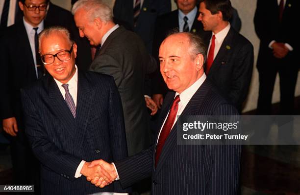 Soviet Premier Mikhail Gorbachev shakes hands with Chairman of the Chinese Communist Party Zhao Ziyang after a meeting.