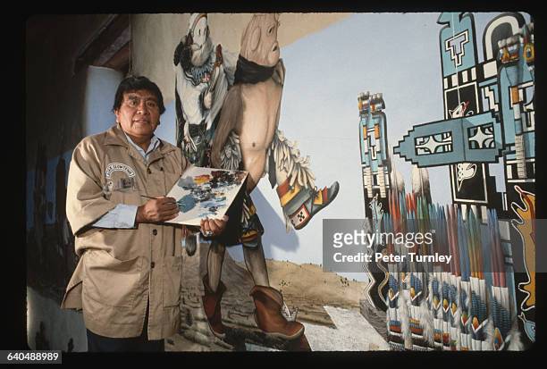 Mural painter Alex Seowtewa paints Kachinas on the walls of Our Lady of Guadalupe Mission | Location: Zuni, New Mexico, USA.