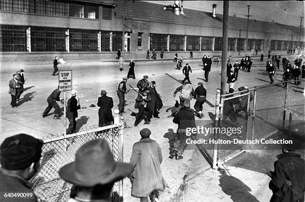 Scab workers in the Ford Plant break up a picket line of strikers near Gate 4.
