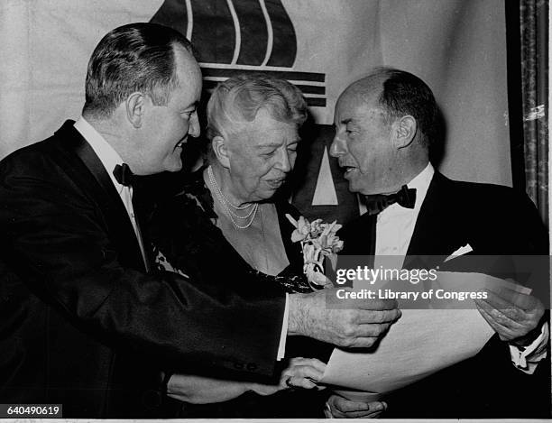 Hubert Humphrey and Eleanor Roosevelt admire the Ada Distinguished National Award presented to Adlai Stevenson at a Roosevelt Day banquet.