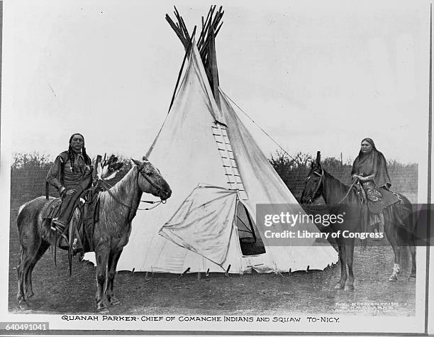 Quanah Parker, the Comanche Chief who resisted the settlement of White cattle ranchers in Texas. Sits atop his horse next to his wife, To-Nicy.