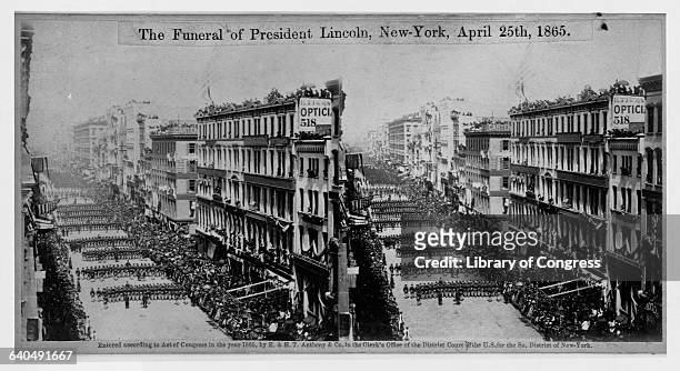 Mourners line the street as President Lincoln's funeral procession passes through New York City on April 25, 1865. Lincoln's body was taken by train...