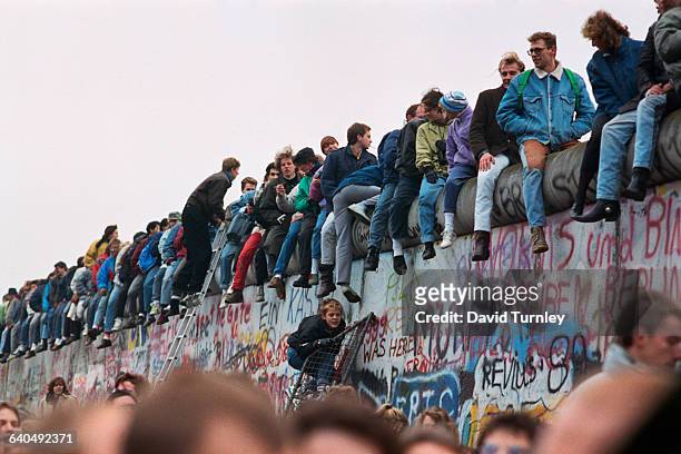 People Sitting on Berlin Wall