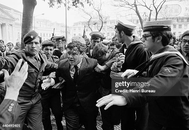 Man, probably a PIDE agent, is escorted by the army after an altercation with the crowd, two days after the April 25 coup d'etat which overthrew the...
