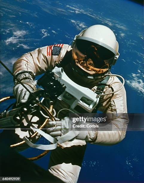 Astronaut Edward H. White EVA, or spacewalking, outside his Gemini rocket in Earth's orbit. 1965. | Location: above Earth.