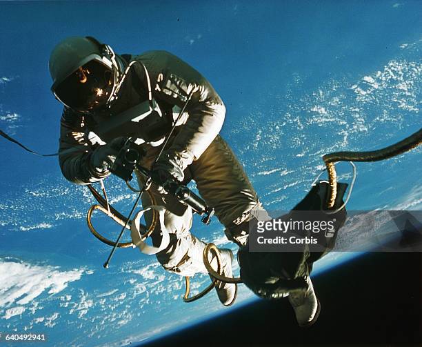 Astronaut Edward H. White EVA, or spacewalking, outside his Gemini rocket. In orbit, 1965. | Location: above Earth.
