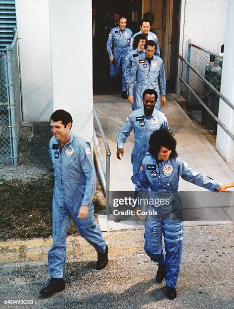 The crew of the Space Shuttle Challenger walk out of the Operations Building at Kennedy Space Center in Florida on their way to launch Pad-39B. Crew...