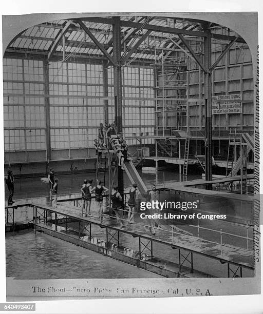 Swimmers line up to go down a slide at the Sutro Baths, built in 1896 adjacent to the Cliff House by Adolf Sutro. San Francisco, California, USA. |...