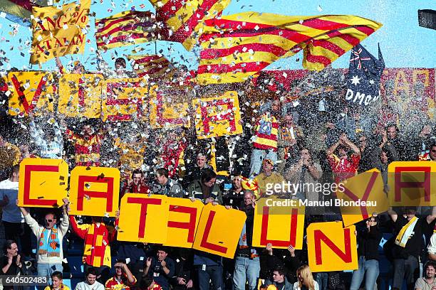 Perpignan fans wave flags and hold up signs amid a flurry of confetti during a Group 6 game of the 2003-2004 Heineken Cup, featuring Perpignan vs....