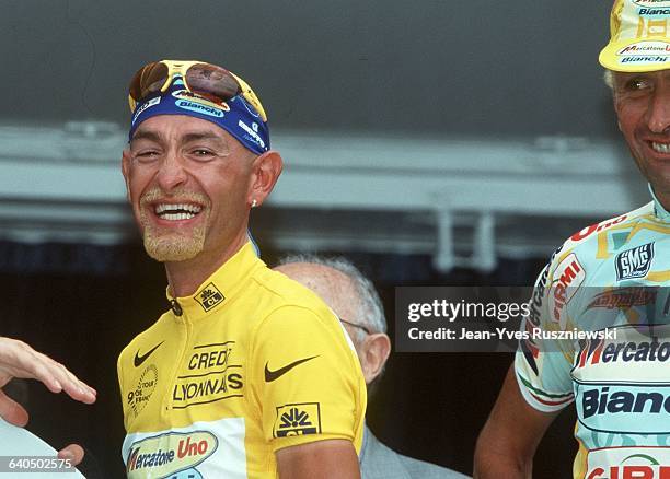 Italian rider Marco Pantani sports the yellow jersey after winning the 1998 Tour de France which finished on the Champs Elysees in Paris after the...