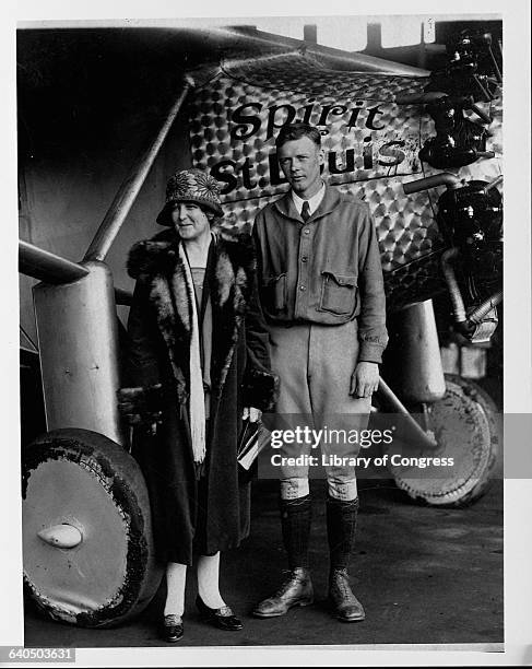 Charles Lindbergh stands next to his mother in front of the Spirit of St. Louis, after he flew solo over the Atlantic Ocean.